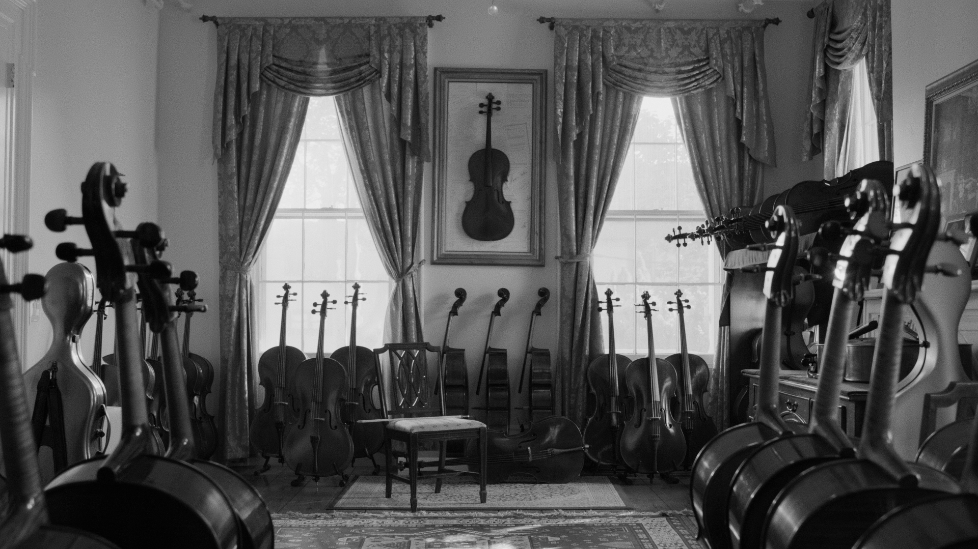 A room filled with cellos and violins beside tall draped windows